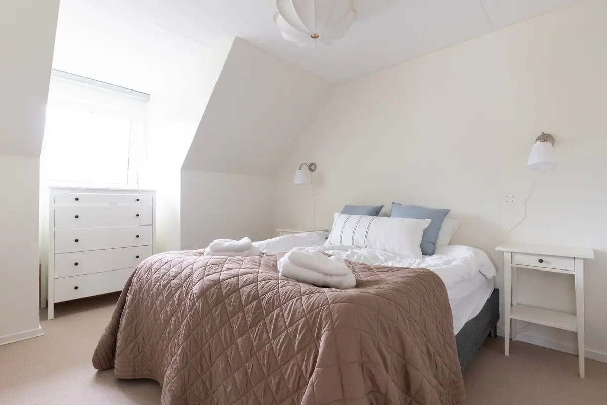 Bedroom with double bed under sloped ceiling