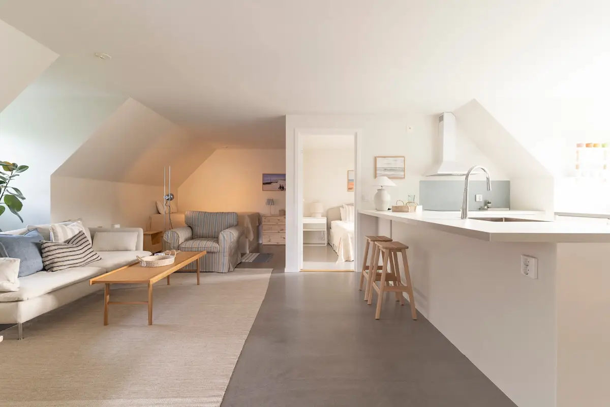 Open living room with sloped ceiling and natural light